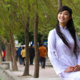 A young Vietnamese woman dressed in an Ao Dai