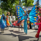 A human butterfly in the Carnival of Cultures Parade, Karneval der Kulturen Umzug -a multicultural music festival in Kreuzberg